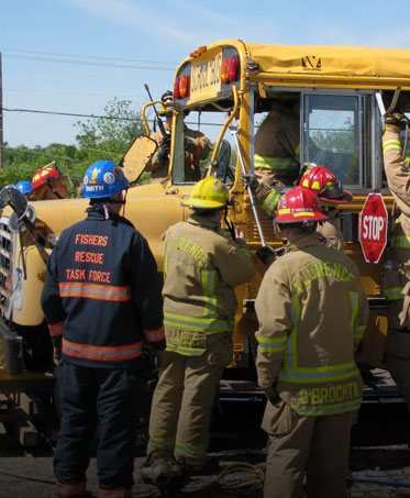Crews from several departments working an extrication drill on a school bus