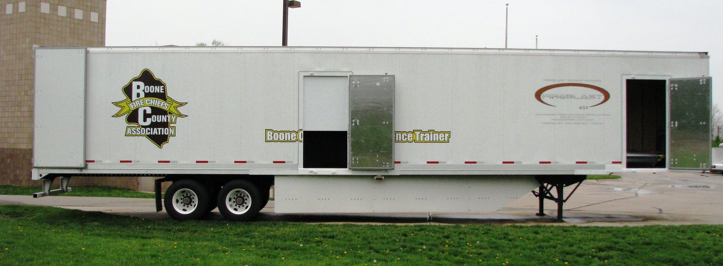 The Boone County Fire Chiefs Association SCBA confidence trainer, a towable trailer unit, parked on grass